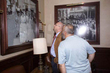 Men admiring an antique photo