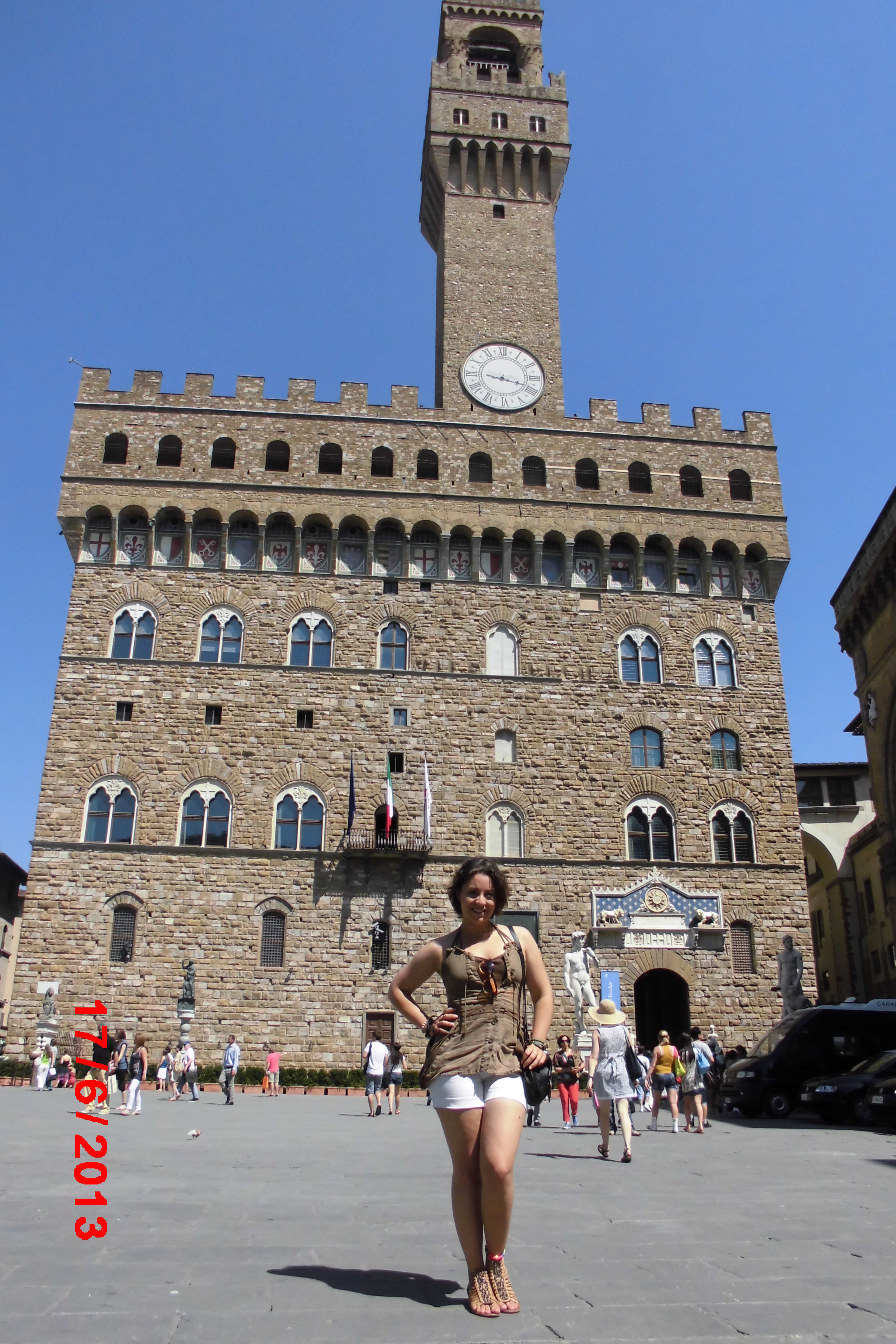 Olivia Vargus in front of large building with clock