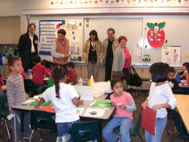 Adults and children in elementary school schoolroom