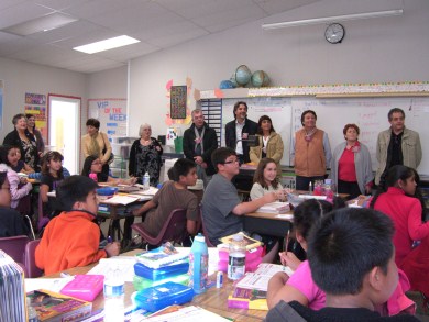 Adults and children in elementary school schoolroom