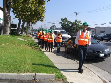 Recyclery Tour - men walking in orange vests, green helmets