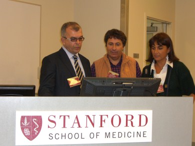 Three people at Stanford  School of Medicine desk